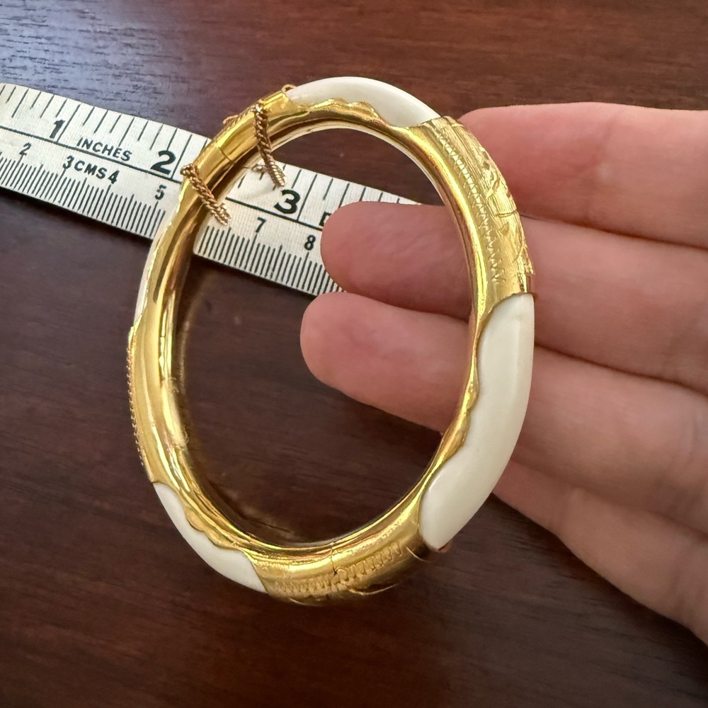 Gold tone ox bone hinged bangle bracelet